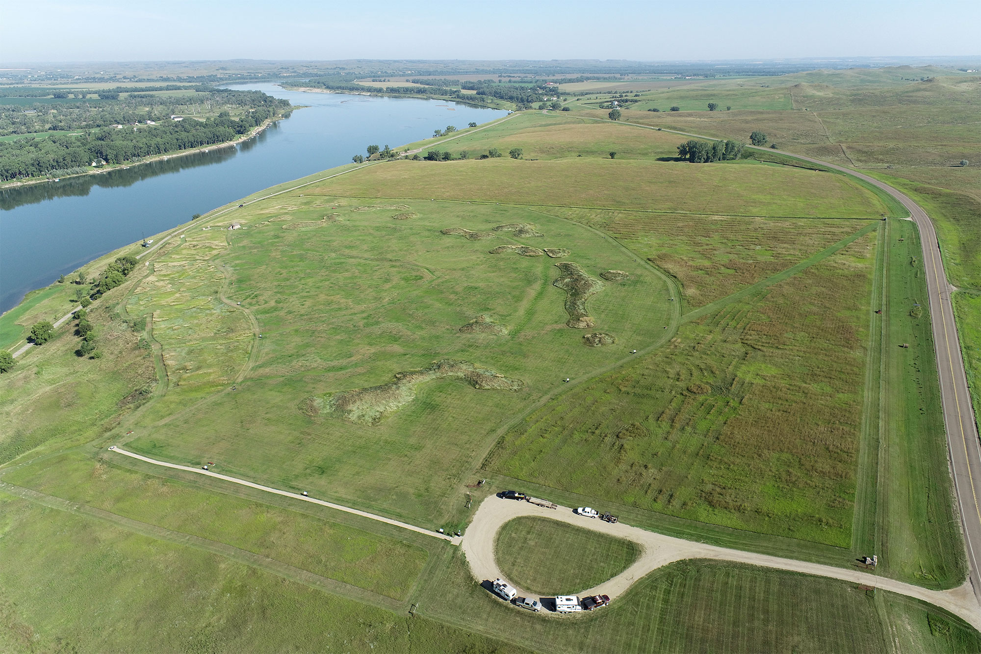 Fortification ditches, earthlodge depressions, midden mounds, and modern features present at Double Ditch are visible in this image captured by an uncrewed aerial vehicle